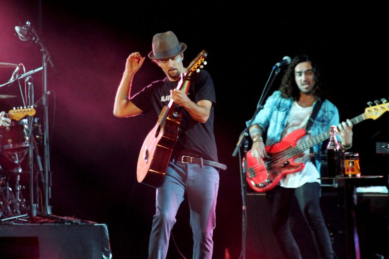   American singer-songwriter Jason Mraz, center, performs at the base of the famous hilltop Shwedagon Pagoda in Yangon, Myanmar, on Sunday, Dec. 16, 2012. Mraz mixed entertainment with education to become the first world-class entertainer in decades to perform in Myanmar, with a concert to raise awareness of human trafficking. (AP Photo/Zin Chit Aung)  