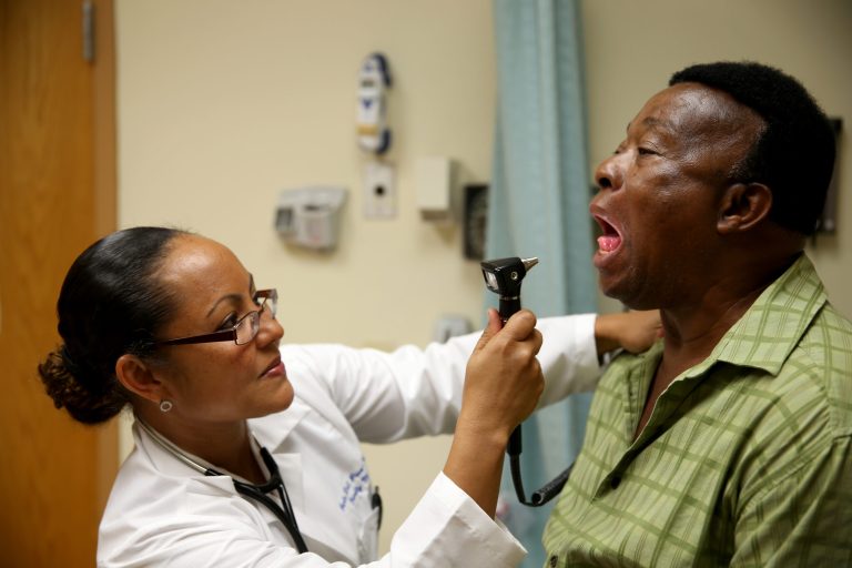 Felue Chang who is newly insured under an insurance plan through the Affordable Care Act receives a checkup from Dr. Peria Del Pino-White at the South Broward Community Health Services clinic on April 15, 2014 in Hollywood, Florida. (Photo by Joe Raedle/Getty Images)