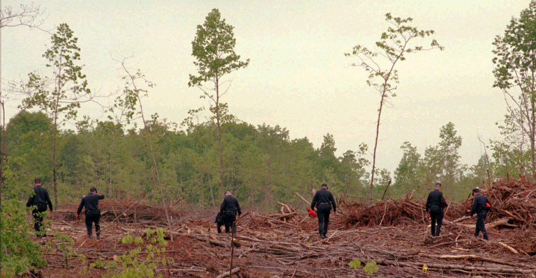 Virginia State Police investigators search the area near where Alicia Showalter Reynolds' body was found outside Culpeper, Va., on Wednesday, May 8, 1996. Reynolds body was found a day earlier in this remote, heavily logged area, nine weeks after she disappeared on March 2, 1996. (AP Photo/Ken Bennett)