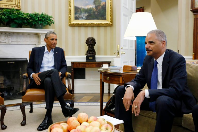 FILE - This Aug. 18, 2014 file photo shows President Barack Obama meeting with Attorney General Eric Holder  in the Oval Office of the White House in Washington. Holder, who is leading the federal response to the racial turmoil in Ferguson, Missouri, talks about the nation's civil rights struggles in a way none of the 81 previous U.S. attorneys general could _ by telling his own family story. (AP Photo/Charles Dharapak, File)