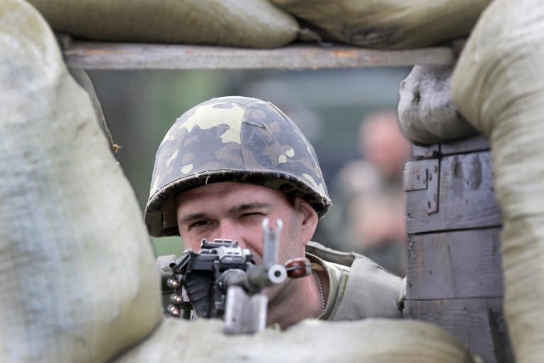 A Ukrainian soldier takes position as he patrols an area, close to Slovyansk, Ukraine, Tuesday, June 3, 2014. Ukrainian troops on Tuesday launched an offensive against pro-Russian insurgents in the eastern city of Slovyansk and advanced through the city's outskirts, the nation's interior minister said. (AP Photo/Efrem Lukatsky)