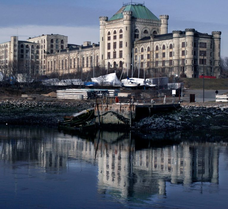 File - In this April 2008 file photo, the prison at the Portsmouth Naval Shipyard is reflected in the Piscataqua River, in Kittery, Maine. The Navy, saying it has received more than one proposal in its latest attempt to enlist the private sector to redevelop the prison, is trying for a third time to breathe life back to life the fortress-like structure that needs millions of dollars of repairs. (AP Photo/Pat Wellenbach, File)