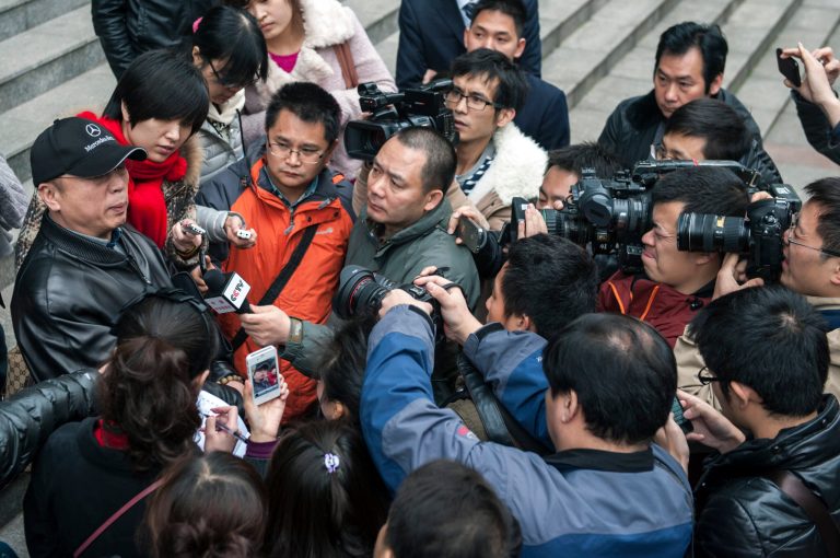   In this photo taken Thursday, Nov. 29, 2012, Li Zhuang, an ex-lawyer who claims he was framed and wrongfully jailed for 18 months, is surrounded by journalists in front of the Chongqing No. 1 Intermediate People's Court in southwest China's Chongqing Municipality. With China's new leaders freshly installed in power, authorities are turning their attention to tying up loose ends in the sprawling, scandal-ridden city once ruled by populist politician Bo Xilai before his downfall buffeted the leadership transition. In the past two weeks, authorities in Chongqing released Li, a lawyer disbarred after being convicted of having one of his clients lie in court, as well as a village official who had been sent to a labor camp for criticizing Bo. (AP Photo) CHINA OUT  