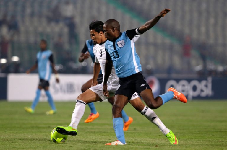 Egypt's Amr Gamal, left, scores his side's opening goal against Botswana during their African Cup of Nations group G qualifying soccer match at  Cairo International Stadium in Cairo, Egypt, Wednesday, Oct. 15, 2014. Egypt won 2-0. (AP Photo/Hassan Ammar)