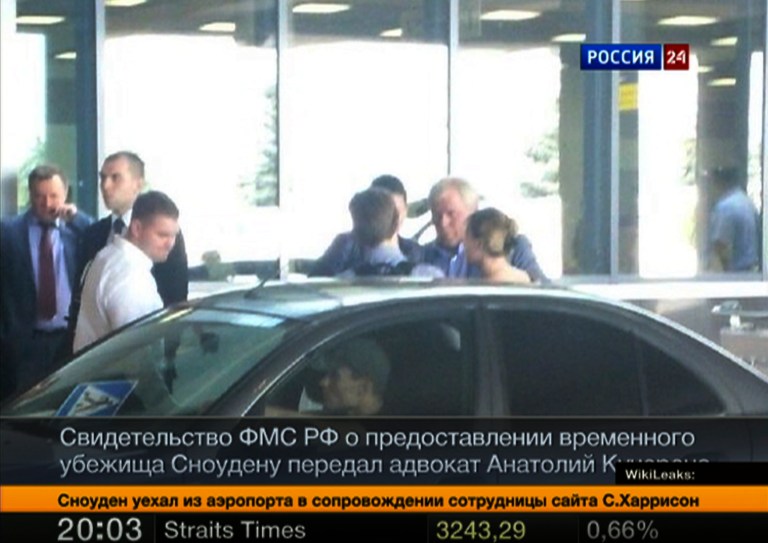   In this still image taken on Thursday, Aug. 1, 2013 and released by Russia24 TV channel, shows Russian lawyer Anatoly Kucherena, second right in the center, and National Security Agency leaker Edward Snowden, center back to a camera, as Snowden leaves Sheremetyevo airport outside Moscow, Russia, on Thursday, Aug. 1, 2013. Snowden has received asylum in Russia for one year and left the transit zone of Moscow's airport, his lawyer said Thursday. Kucherena said that Snowden's whereabouts will be kept secret for security reasons. (AP Photo/Russia24 via Associated Press Television) TV OUT  