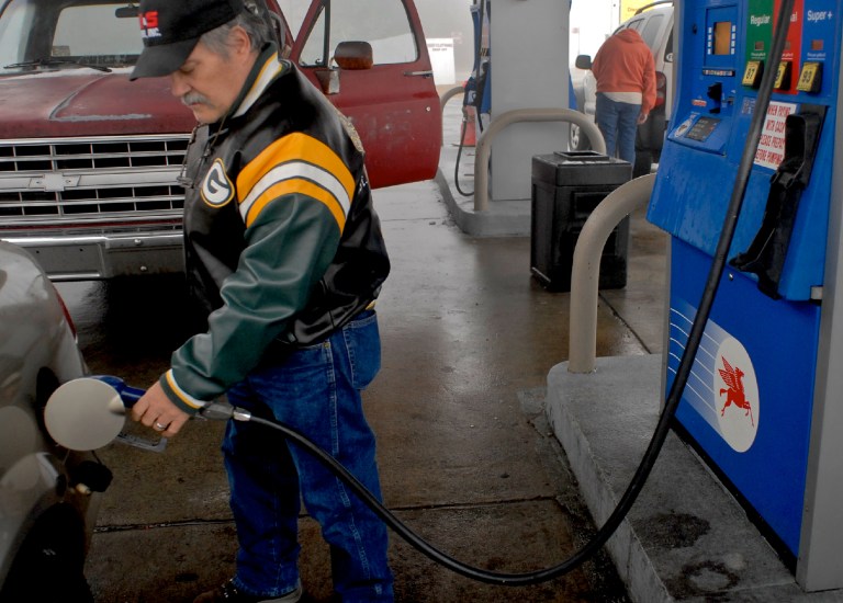 Ron Jones, of Frackville, Pa., pumps gas at the Mobil station along Route 61 in Saint Clair, Pa., on Sunday, Jan. 4, 2015. (AP Photo/Republican-Herald, Andy Matsko)