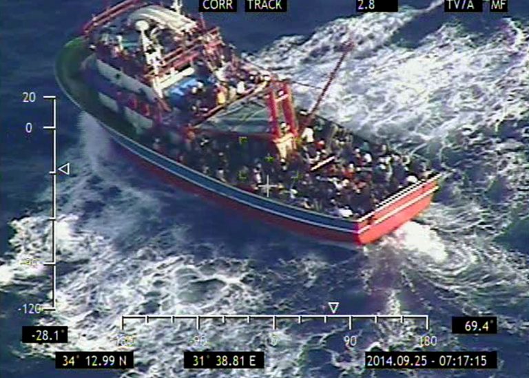 In this photo provided the Cypriot Defense Ministry, a small vessel loaded with 353 people who are believed to be refugees fleeing Syria lies around 50 nautical miles southwest of Cyprus' coast on Thursday, Sept. 25, 2014. A cruise ship picked up all 353 people from the boat after it sent out a distress signal amid bad weather, and is making for Cyprus' main port of Limassol. (AP Photo/Cypriot Defense Ministry, HO)