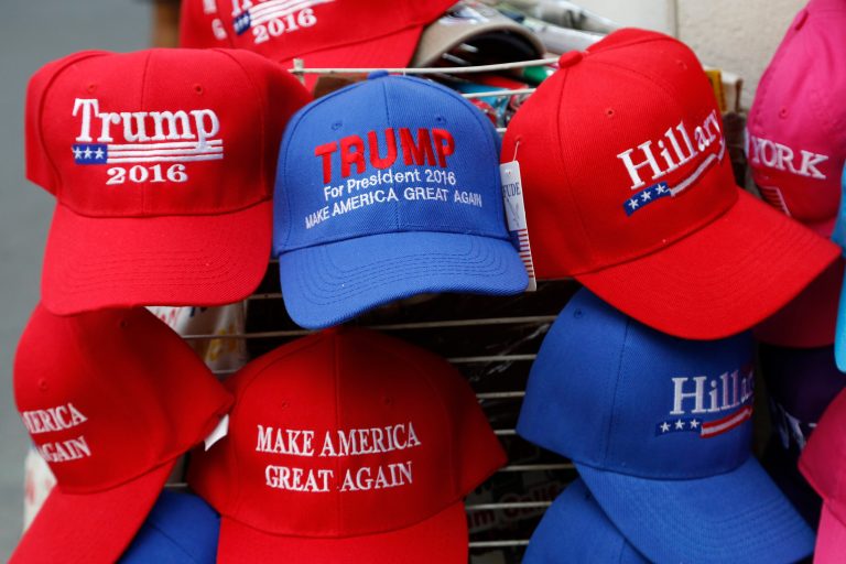 Hats displaying support for Republican presidential candidate Donald Trump and his Democratic opponent Hillary Clinton are displayed by a sidewalk vendor, Tuesday, Aug. 16, 2016, in New York. (AP Photo/Mark Lennihan)