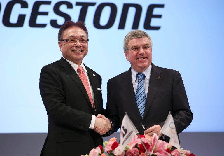 International Olympic Committee (IOC) President Thomas Bach, right, and Bridgestone Corp. CEO Masaaki Tsuya pose for photographers during a press conference in Tokyo, Friday, June 13, 2014. Japanese tire manufacturer Bridgestone signed an agreement on Friday to become a top-tier sponsor of the IOC in a 10-year deal that will cover the 2020 Tokyo Games. Bridgestone officials declined to reveal financial terms of the deal but the Asahi Shimbun newspaper reported that Bridgestone will pay $344 million to become a worldwide sponsor under the IOC's global commercial program, known as TOP. (AP Photo/Koji Sasahara)