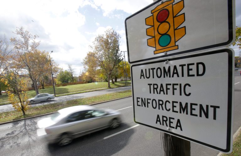In this Oct. 29, 2014 file photo, motorists drive past a sign warning of upcoming traffic cameras in Cleveland. The Ohio Supreme Court on Wednesday, Feb. 18, 2015, rejected a driver's motion to reconsider their 4-3 ruling in December. (AP)