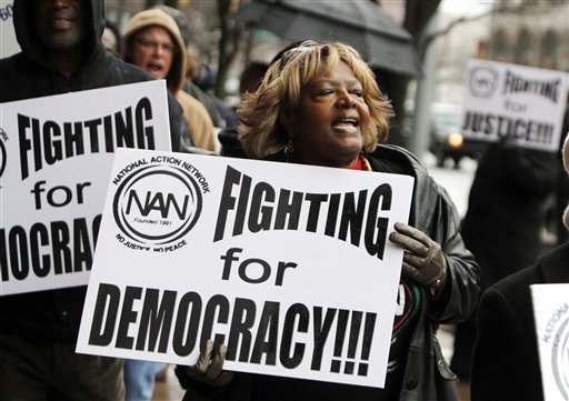 Terri Jeffery, of Detroit marches and chants during an anti right-to-work protest outside of Cadillac Place in Detroit,  Monday, Dec. 10, 2012.  About 50 protesters picketed Monday outside Michigan government offices Monday in downtown Detroit, chanting slogans.   (AP Photo/Detroit Free Press, Andre J. Jackson)  DETROIT NEWS OUT;  NO SALES