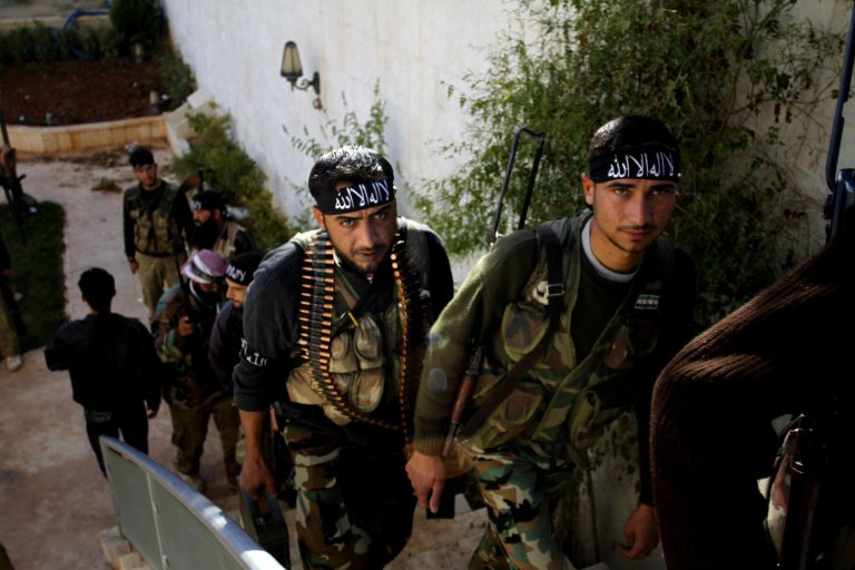   In this Wednesday, Nov. 14, 2012 photo, Syrian fighters of âThe Beloved of Allah,â brigade hold their weapons before fighting with government forces on the outskirts of Aleppo. The Beloved of Allah began with ten men, five rifles, one rickety machine gun and a few rocket-propelled grenades soon discovered to be duds. It was born in Maaret Misreen, a town where tractors nearly outnumber cars between the provincial capital of Idlib and the Turkish border to the north. Their leader, 35-year-old Mustafa Filfileh, had no military experience and little idea how to face one of the Mideast's strongest armies. He didn't even know how to drive. They learned fast. In November, the brigade called âThe Beloved of Allahâ braced for its biggest challenge yet, one that would make clear how far its members had come and how far the war had brought them from their former lives. (AP Photo/Khalil Hamra)  