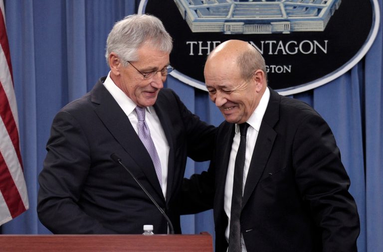 Defense Secretary Chuck Hagel, left, talks with France's Minister of Defense Jean-Yves Le Drian, right, at the end of a news conference at the Pentagon in Washington, Friday, Jan. 24, 2014. (AP Photo/Susan Walsh)