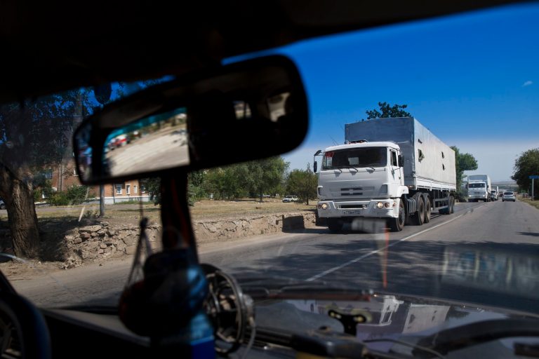 Trucks move towards a border control point with Ukraine in the Russian town of Donetsk, Rostov-on-Don region, Russia, Friday, Aug. 22, 2014. The first trucks of the Russian aid convoy crossed the Ukrainian inspection zone Friday morning. (AP Photo/Pavel Golovkin)
