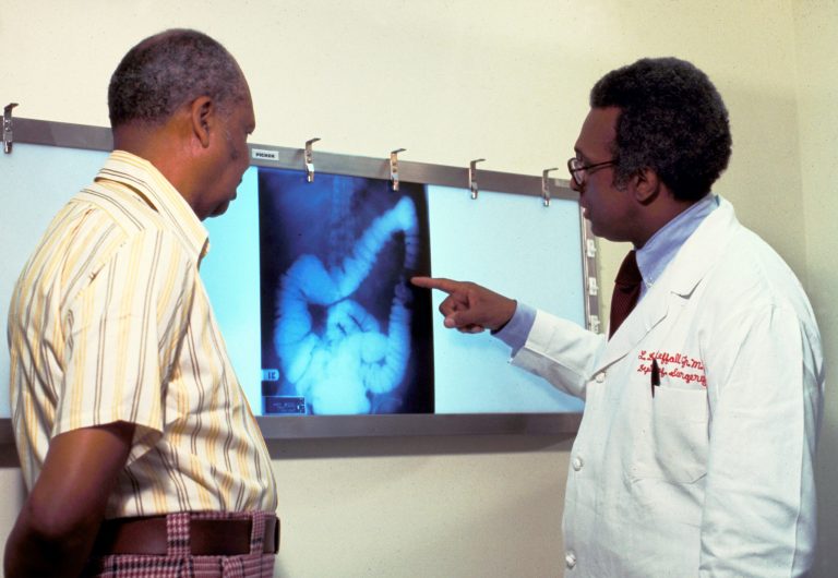 In this file photo, a doctor goes over a patient''s x-ray, screening for colon cancer. There is no single cause of colon cancer. Cancer of the colon and rectum accounts for 15% of cancer deaths. (Photo by American Cancer Society/Getty Images)