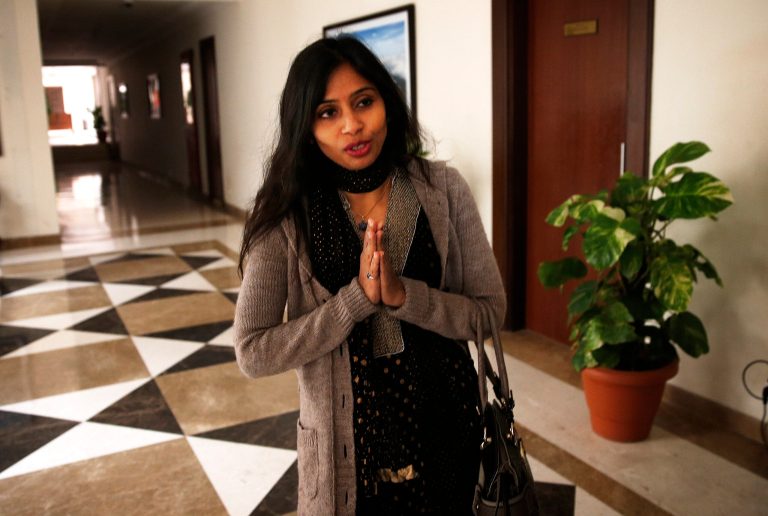 Devyani Khobragade, who served as India's deputy consul general in New York, greets journalists as she leaves Maharastra State House in New Delhi, India, on Saturday. (AP Photo/Saurabh Das)