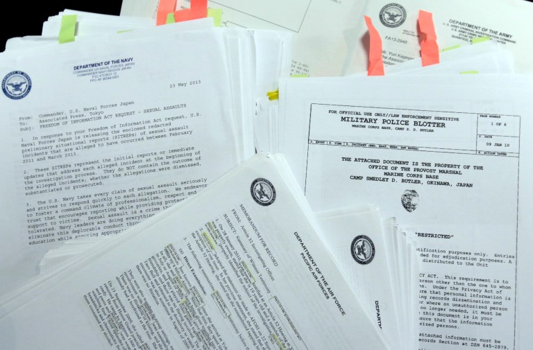 In this Jan. 29, 2014, file photo, parts of more than 1,000 summeries of sex-crime cases involving U.S. military personnel stationed in Japan, which The Associated Press obtained following Freedom of Information Act requests filed with the Army, Navy, Air Force, Marines and Naval Criminal Investigative Service, are displayed at the AP office in Tokyo. (AP Photo)