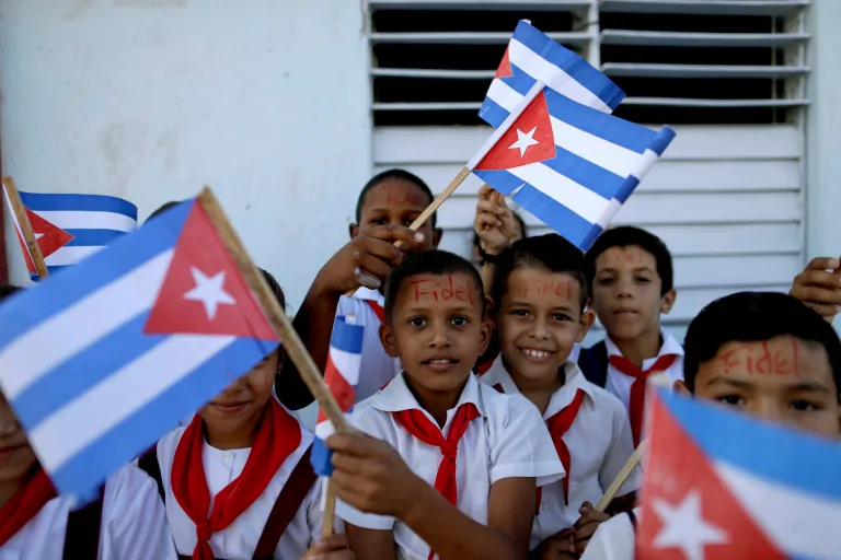 Children in La Esperanza, Cuba, wait in the street for the passing of Fidel Castro's funeral procession on Nov. 30 that retraces his march into Havana nearly six decades ago. (AP Photo/Natacha Pisarenko)