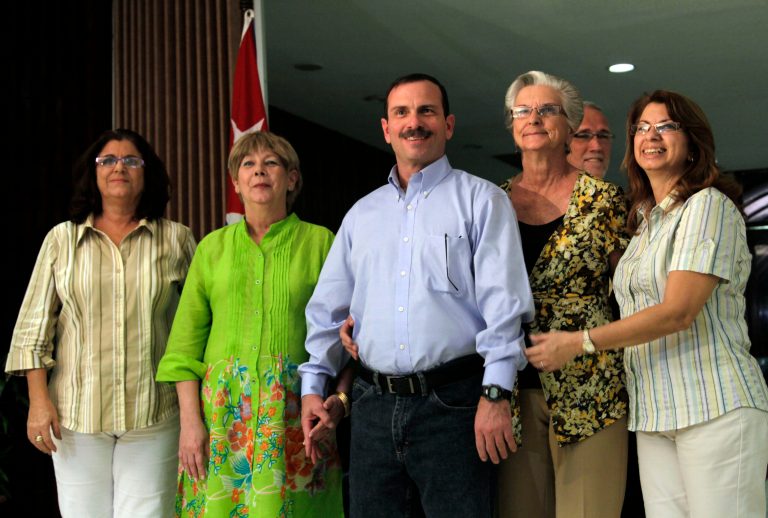 Fernando Gonzalez poses with family members after his arrival at the Jose Marti International Airport in Havana, Cuba, Friday, Feb. 28, 2014. A second member of the 