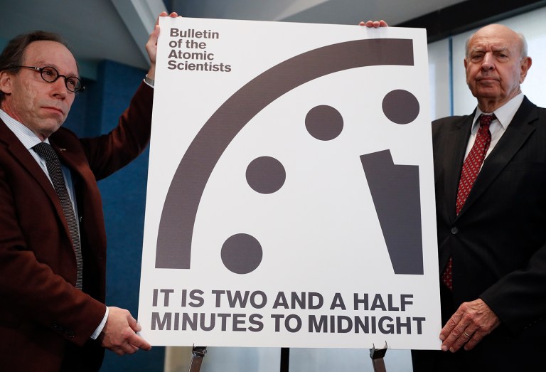 Lawrence Krauss, theoretical physicist, chair of the Bulletin of the Atomic Scientists Board of Sponsors, left, and Thomas Pickering, co-chair of the International Crisis Group, display the Doomsday Clock during a news conference the at the National Press Club in Washington, Thursday, Jan. 26, 2017, announcing that the Bulletin of the Atomic Scientists have moved the minute hand of the Doomsday Clock to two and a half minutes to midnight. (AP Photo/Carolyn Kaster)