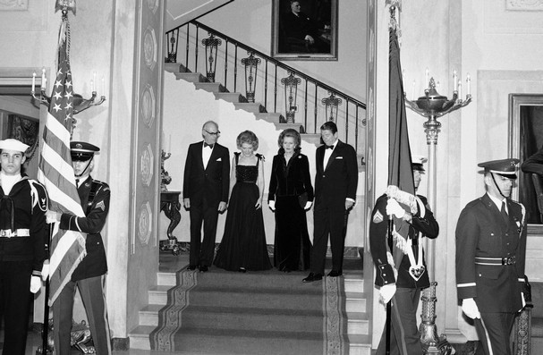 President Ronald Reagan escorts British Prime Minister Margaret Thatcher to the state floor of the White House for a state dinner Washington. Mrs. Thatcher's husband, Denis, and first lady Nancy Reagan are on the left. (AP Photo)