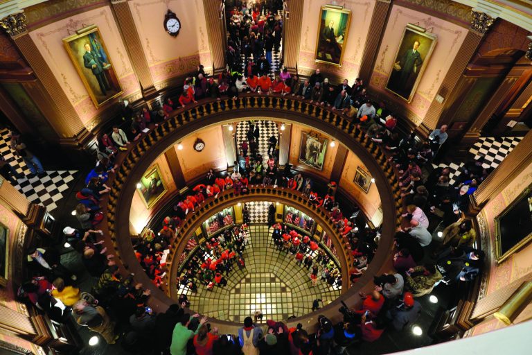 Protesters gather for a rally in the State Capitol rotunda in Lansing, Mich., Tuesday, Dec. 11, 2012. The crowd is protesting right-to-work legislation passed last week. Michigan could become the 24th state with a right-to-work law next week. Rules required a five-day wait before the House and Senate vote on each other's bills; lawmakers are scheduled to reconvene Tuesday and Gov. Snyder has pledged to sign the bills into law. (AP Photo/Paul Sancya)