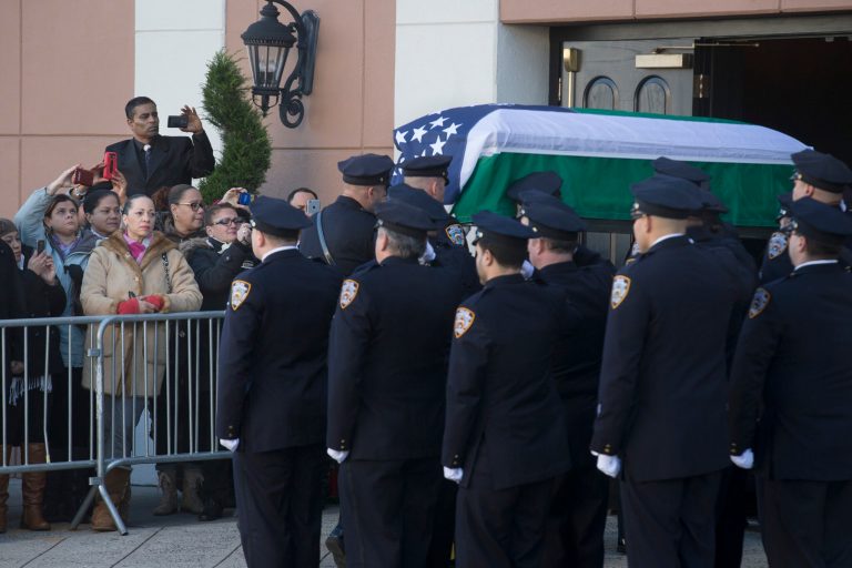 The casket of New York Police Department officer Rafael Ramos arrives to his wake at Christ Tabernacle Church in the Glendale section of Queens, where he was member, Friday in New York. (AP/John Minchillo)