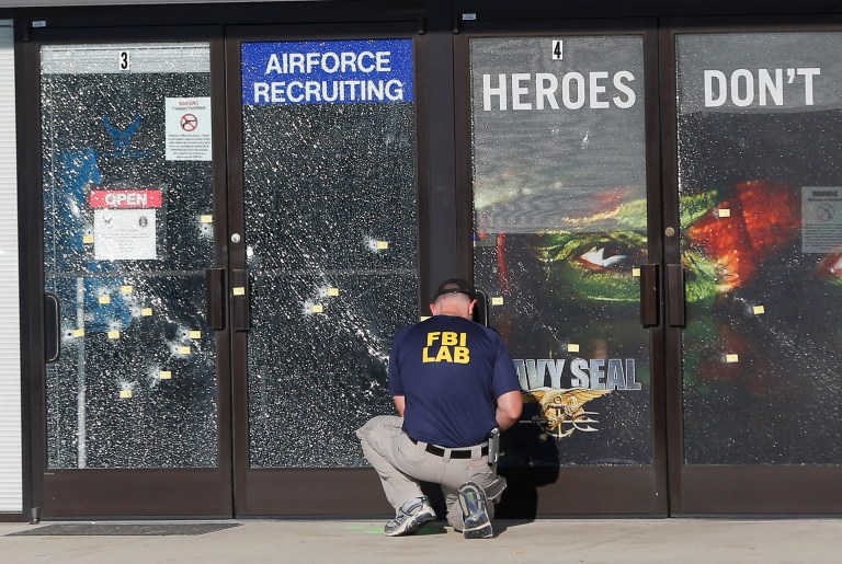 An FBI investigator investigates the scene of a shooting outside a military recruiting center in Chattanooga, Tenn. (AP Photo/John Bazemore, File)