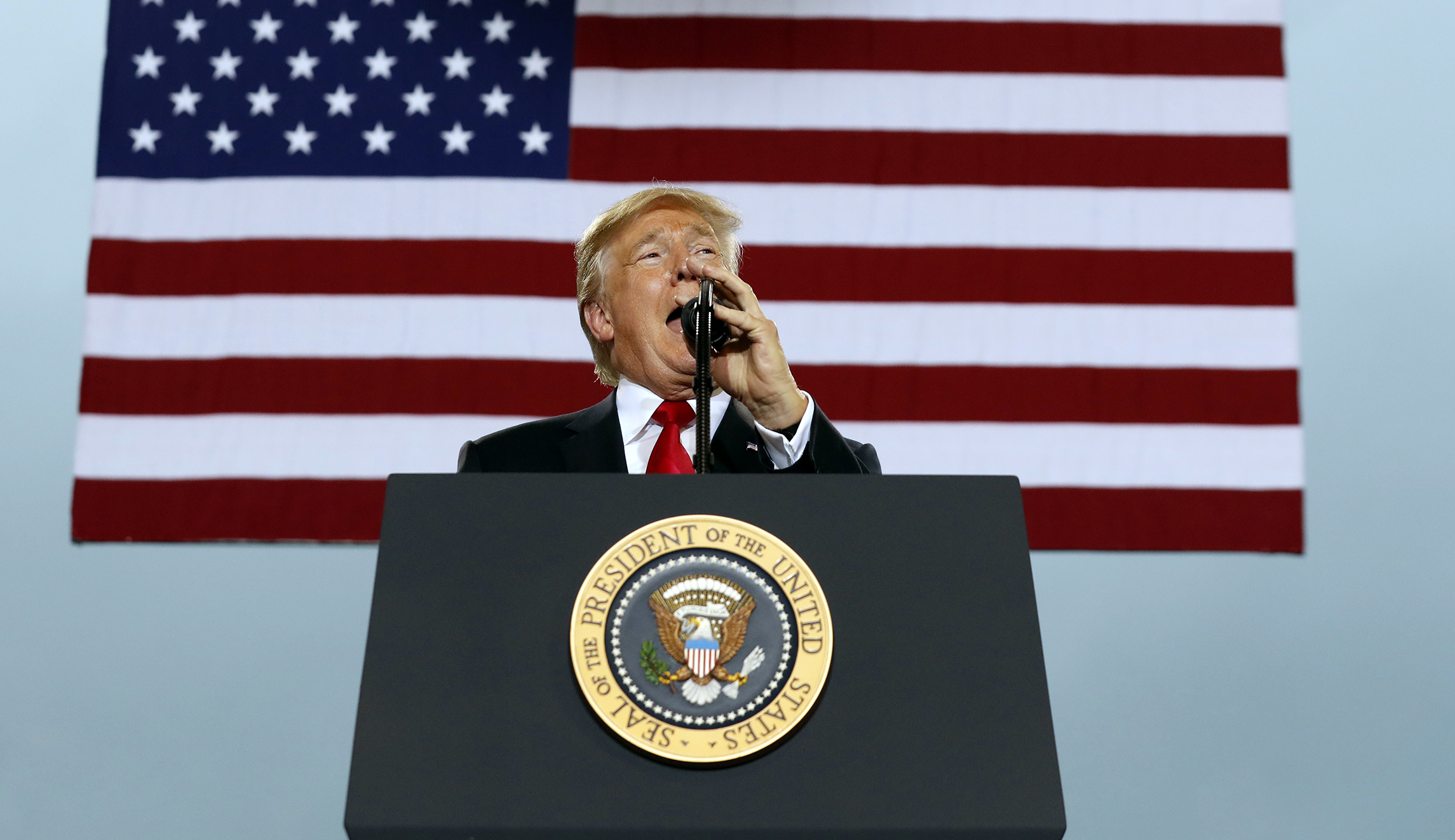 Trump sits, talks through song lowering the flag at military base amid NFL anthem controversy