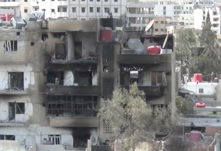 This image taken from video obtained from the Shaam News Network, which has been authenticated based on its contents and other AP reporting, shows a damaged building due to heavy shelling in the Damascus suburb of Daraya, Syria, on Wednesday, April 3, 2013. (AP Photo/Shaam News Network via AP video)