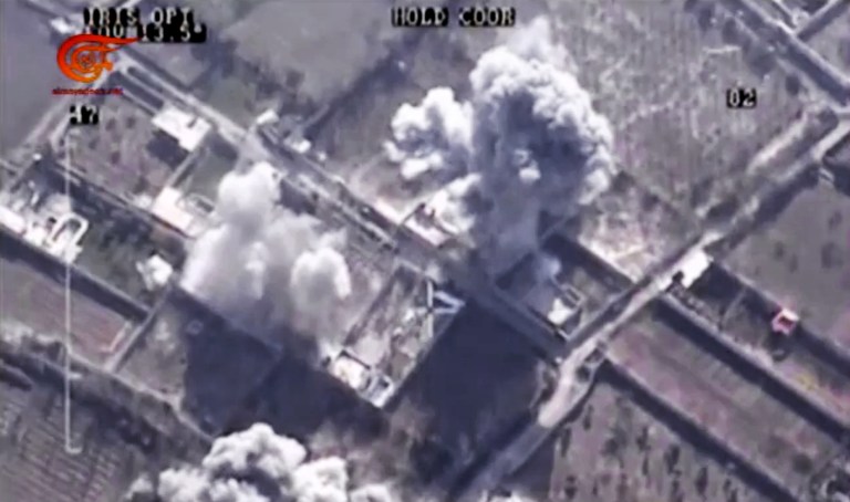 This image made from video made available by Al-Mayadeen, government-controlled Syrian Television, which has been verified and is consistent with other AP reporting shows, drone footage allegedly showing Syrian army airstrikes targeting Zahran Allouch. (Al-Mayadeen via AP video)