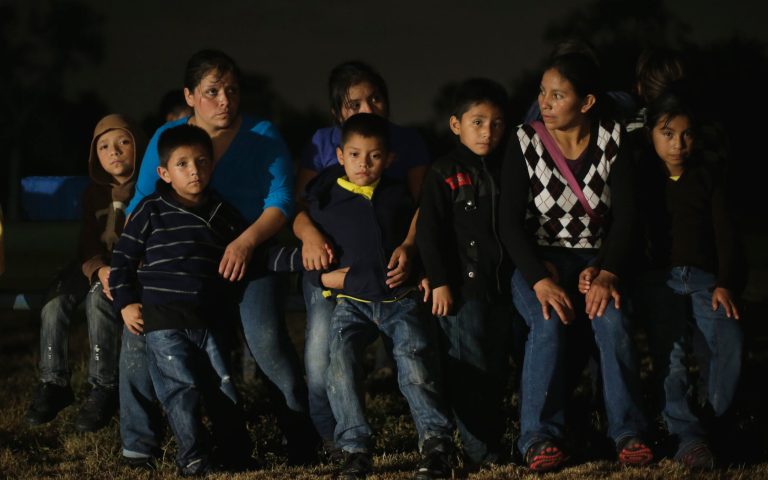A group of immigrants from Honduras and El Salvador who crossed the U.S.-Mexico border illegally are stopped, Wednesday, June 25, 2014, in Granjeno, Texas. (AP Photo/Eric Gay)