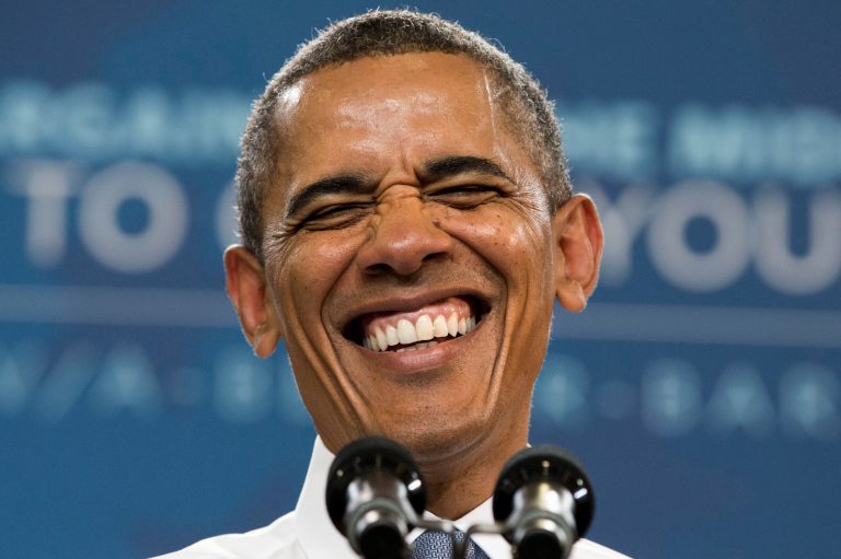FILE - In this Aug. 6, 2013, file photo. President Barack Obama laughs as the crowd sings him 