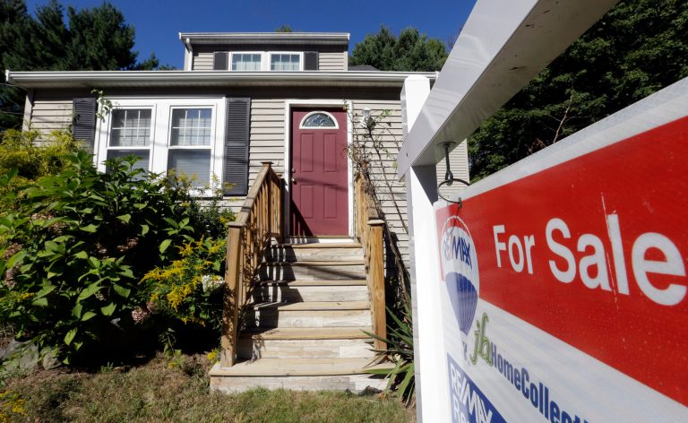   In this Wednesday, Sept. 18, 2013 photo a for sale sign hangs in front of a house in Walpole, Mass. Freddie Mac reports on mortgage rates for the last week of September on, Thursday, Oct. 3, 2013. (AP Photo/Steven Senne)  