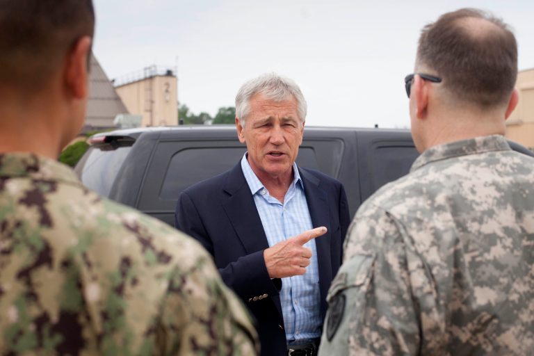 Defense Secretary Chuck Hagel speaks with members of his military staff before boarding his plane prior to his departure from Andrews Air Force Base, Md., Wednesday, May 28, 2014. Hagel is traveling on a 12-day trip to Asia and Europe, his fourteenth international trip, to discuss key regional and global issues with leaders of several countries. (AP Photo/Pablo Martinez, Pool)