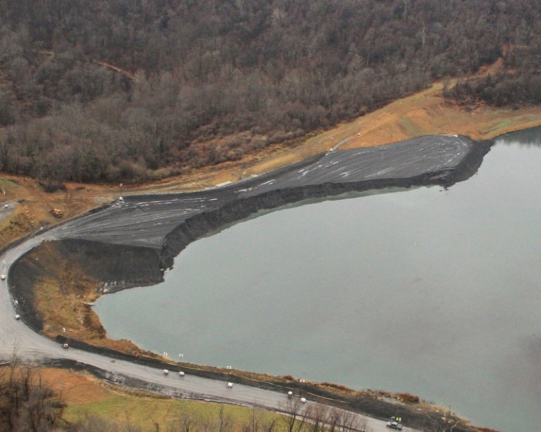   This Dec. 3, 2012 photo provided by the W.Va. Department of Environmental Protection shows the embankment after a collapse at the Consol's Robinson Run operation in Harrison County, W. Va. Crews continued to look for a missing miner and bulldozer that slid into the impoundment with two trucks and two engineers when an embankment under construction internal to the impoundment collapsed around noon on Friday, Nov. 30. (AP Photo/W.Va. Department of Environmental Protection)  