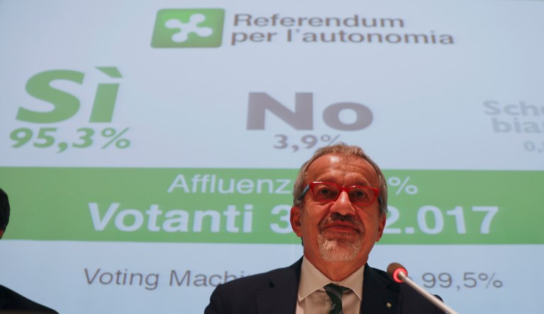 Lombardy Region President Roberto Maroni speaks during a news conference at the Lombardy Region headquarters, in Milan, Italy, Monday, Oct. 23, 2017. The presidents of Italy's wealthy northern regions of Veneto and Lombardy on Sunday claimed victory in autonomy referendums that seek to grab additional powers and tax revenue from Rome, riding a global tide of self-determination that has swamped Spain's Catalonia region. In the background the results under the Yes(Si) read 95.3%. (AP Photo/Luca Bruno)