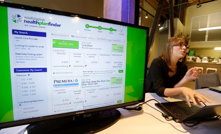 Nelly Kinsella demonstrates the Washington Healthplanfinder website, where consumers will be able to shop for health insurance, Monday, in Seattle. The new site, which allows consumers to compare and purchase health insurance plans and to see if they are eligible for government subsidies, is Washington state's online answer to the Affordable Care Act. (AP Photo/Elaine Thompson)