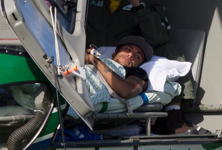 Brazil's Neymar lies inside a medical helicopter at the Granja Comary training center, in Teresopolis, Brazil, Saturday, July 5, 2014. Neymar was airlifted from Brazil's training camp Saturday and will be treated at home for his back injury. Neymar, the biggest football star in Brazil, was ruled out of the rest of the World Cup after fracturing his third vertebra during Friday's 2-1 quarterfinal win over Colombia. (AP Photo/Leo Correa)