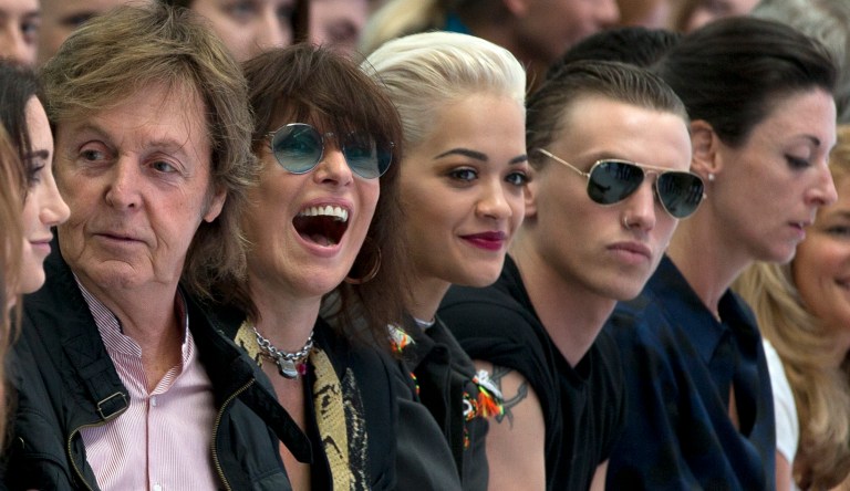 From left, Paul McCartney, Chrissie Hynde, Rita Ora  and Jamie Campbell Bower sit in the from row during the Hunter Original,  Spring/Summer 15 show at London Fashion Week in London, Saturday, Sept. 13, 2014. (AP Photo/Alastair Grant)