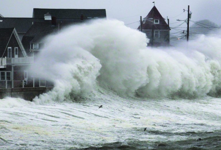 Waves crash into a seawall and buildings along the coast in Hull, Mass., Wednesday, Nov. 7, 2012. A high-wind warning is in effect in the state until Wednesday night, with gusts of up to 60 mph expected in some costal areas, and 50 mph gusts expected for Boston and western Massachusetts. (AP Photo/Steven Senne)