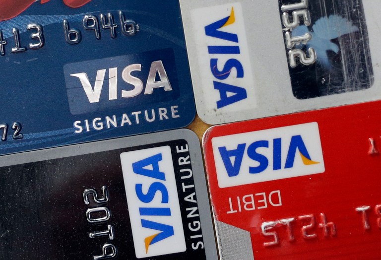 FILE - In this April 25, 2013 file photo, credit and debit cards are displayed for a photographer in Baltimore. Visa Inc. reports quarterly earnings on Thursday, April 24, 2014. (AP Photo/Patrick Semansky, File)