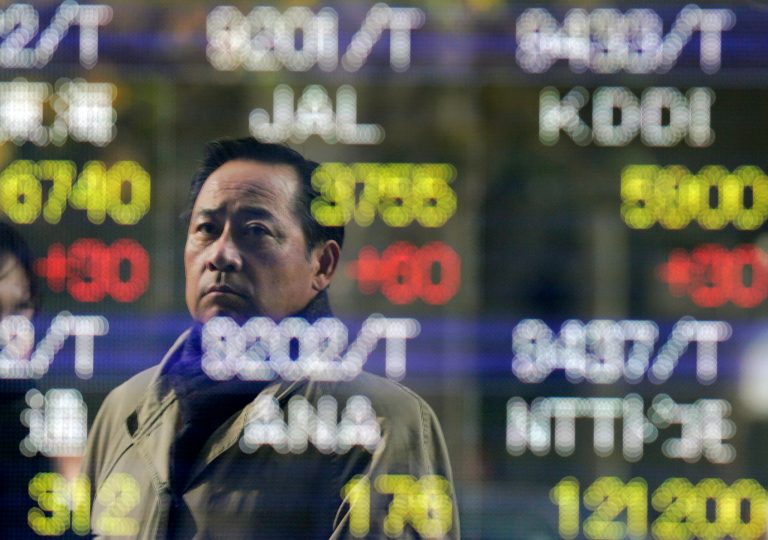   A man checks the electronic stock board of a securities firm in Tokyo, Tuesday, Dec. 18, 2012. Asian stock markets were mostly higher Tuesday, boosted by signs China's recovery is gaining traction and hopes for a new stimulus in Japan. (AP Photo/Itsuo Inouye)  