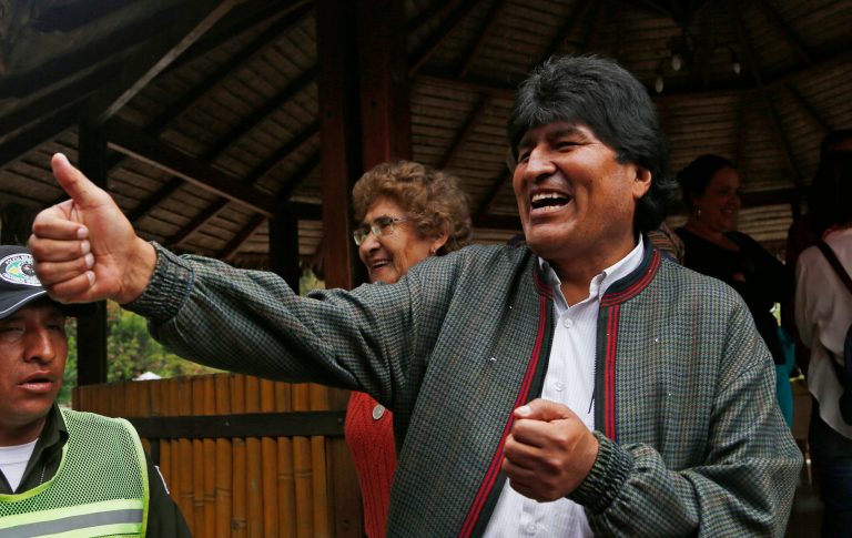 Bolivia's President Evo Morales gives a thumbs up to people at a trout farm where he stopped to eat in Paracti, Bolivia, Saturday, Oct. 11, 2014. Morales stopped here to eat as he traveled to the city where he'll vote in tomorrow's general election. Morales is running for a third term in Sunday's presidential elections. (AP Photo/Juan Karita)