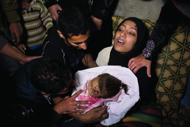 The mother of 10-month-old Palestinian infant Haneen Tafesh holds the dead body of her daughter prior to a funeral in Jabaliya, north Gaza, Friday, Nov. 16, 2012. According to hospital reports Tafesh died from wounds of an earlier Israeli strike. (AP Photo/Bernat Armangue)