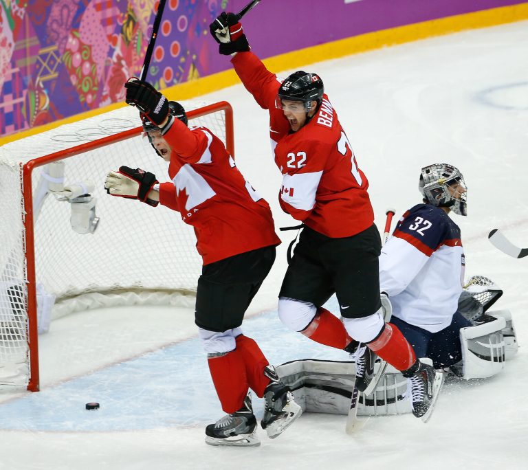Canada forward Benn Jamie (22) celebrates his goal against USA goaltender Jonathan Quick (32) during the second period of the men's semifinal ice hockey game at the 2014 Winter Olympics, Friday, Feb. 21, 2014, in Sochi, Russia. (AP Photo/Matt Slocum)