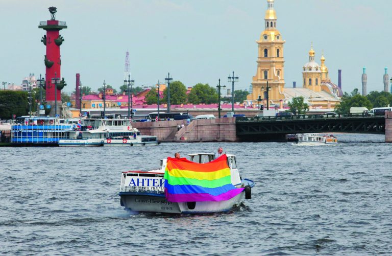 FILE- In this Saturday, June 25, 2011 file photo, a boat carrying a rainbow flag sails on the Neva River during a gay rights rally in St. Petersburg, Russia. A controversial bill banning 
