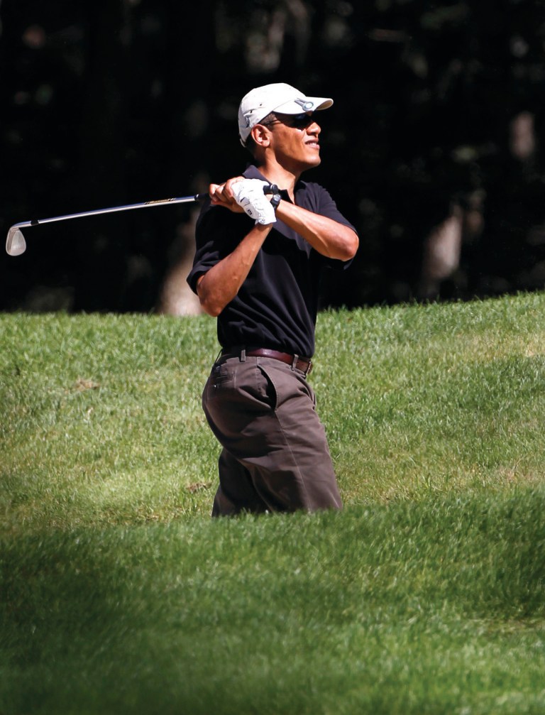 Steven Senne/AP file 
President Obama watches the flight of his ball after hitting out of a trap.