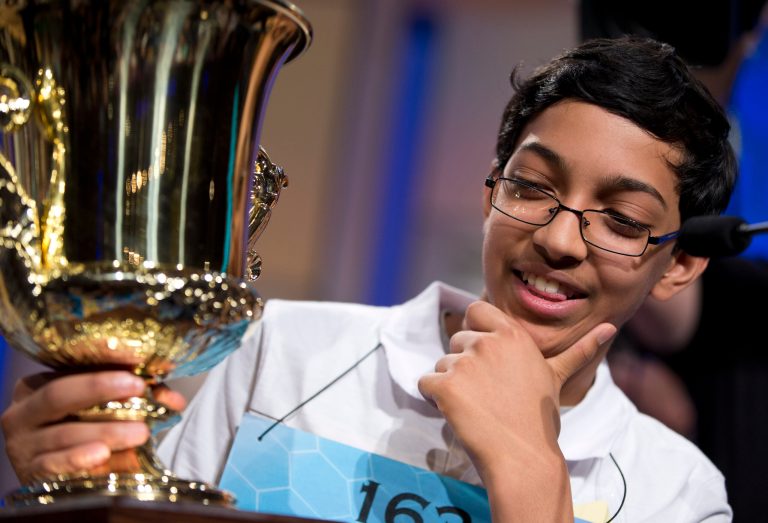 Arvind Mahankali, 13, of Bayside Hills, N.Y., holds the championship trophy after he won the National Spelling Bee by spelling the word 