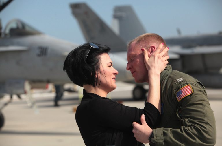 Christy Brugger greets her husband Lt. Mike Brugger as the 